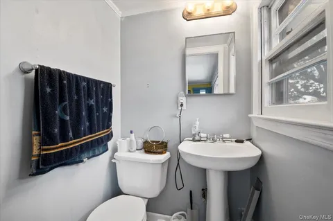 a bathroom with a sink toilet and mirror