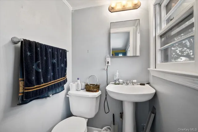 a bathroom with a sink toilet and mirror