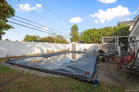 a view of a deck with chairs next to yard