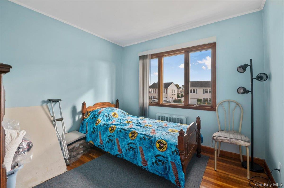 26 Bradford Lane Bethpage, NY 11714 - Photo 8 of 24 a bedroom with a bed and a window