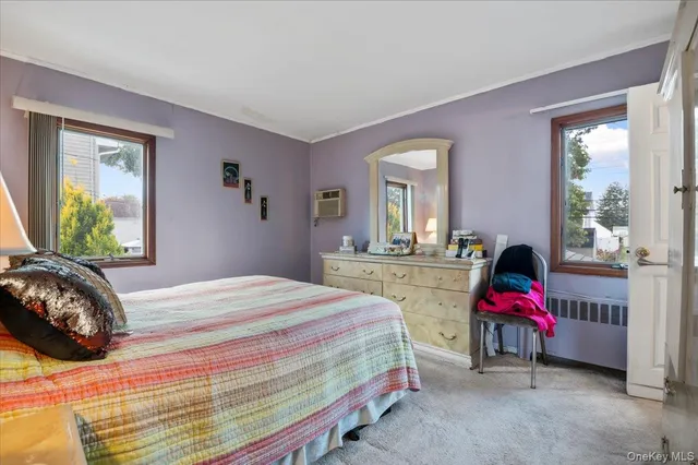 a bedroom with bed and window