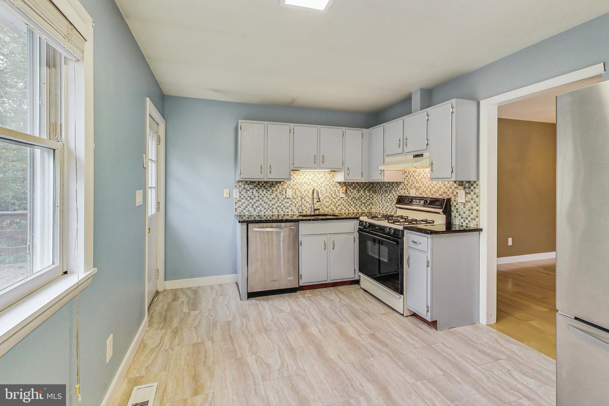 412 Walnut Drive Annapolis, MD 21403 - Photo 11 of 42 a kitchen with granite countertop white cabinets and white appliances