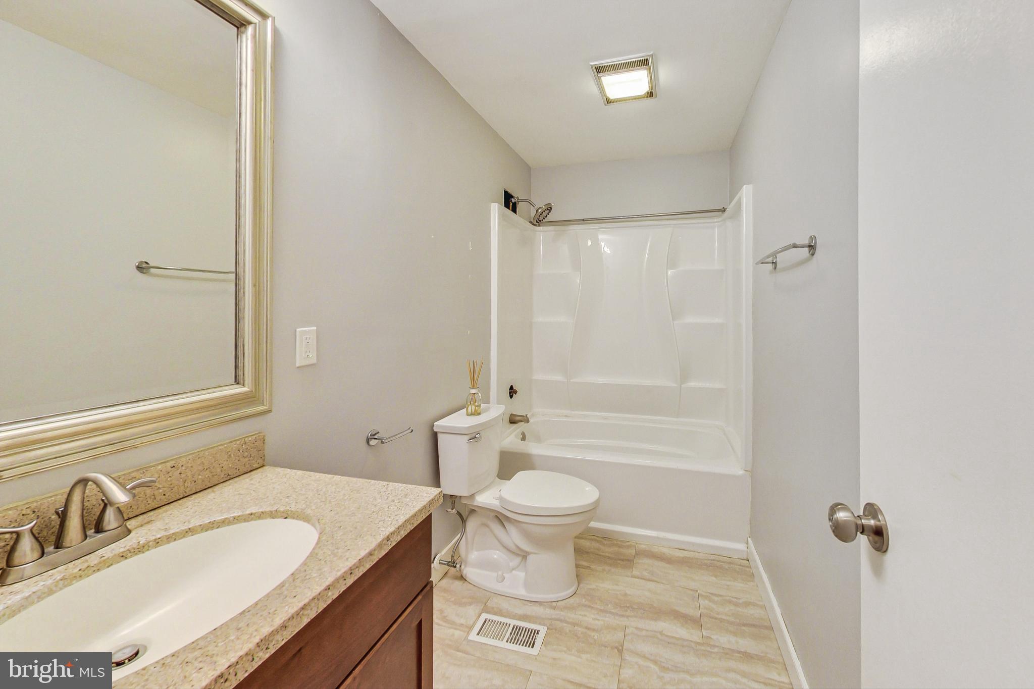 412 Walnut Drive Annapolis, MD 21403 - Photo 21 of 42 a bathroom with a granite countertop sink toilet a mirror and shower