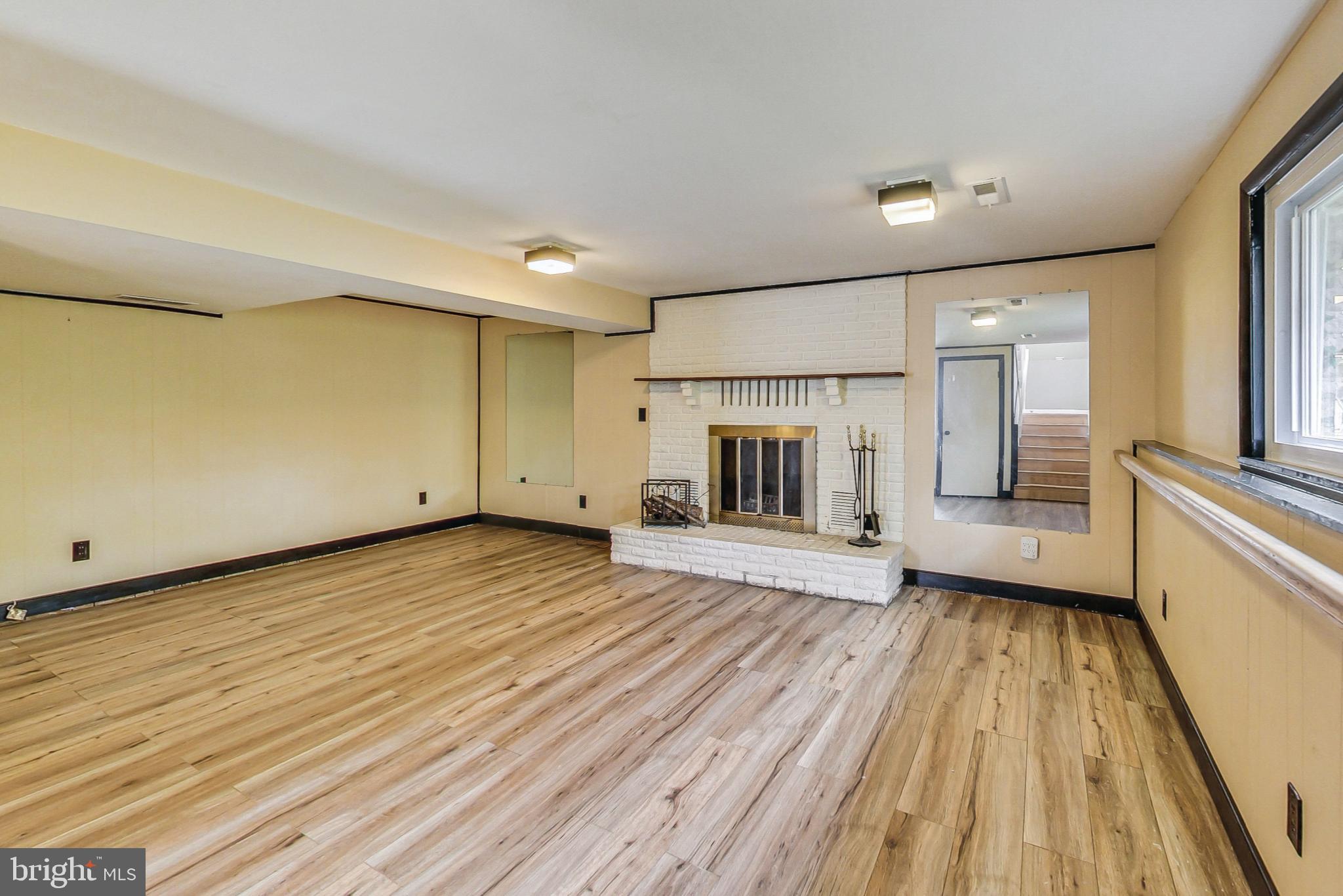412 Walnut Drive Annapolis, MD 21403 - Photo 23 of 42 a view of empty room with a fireplace and wooden floor