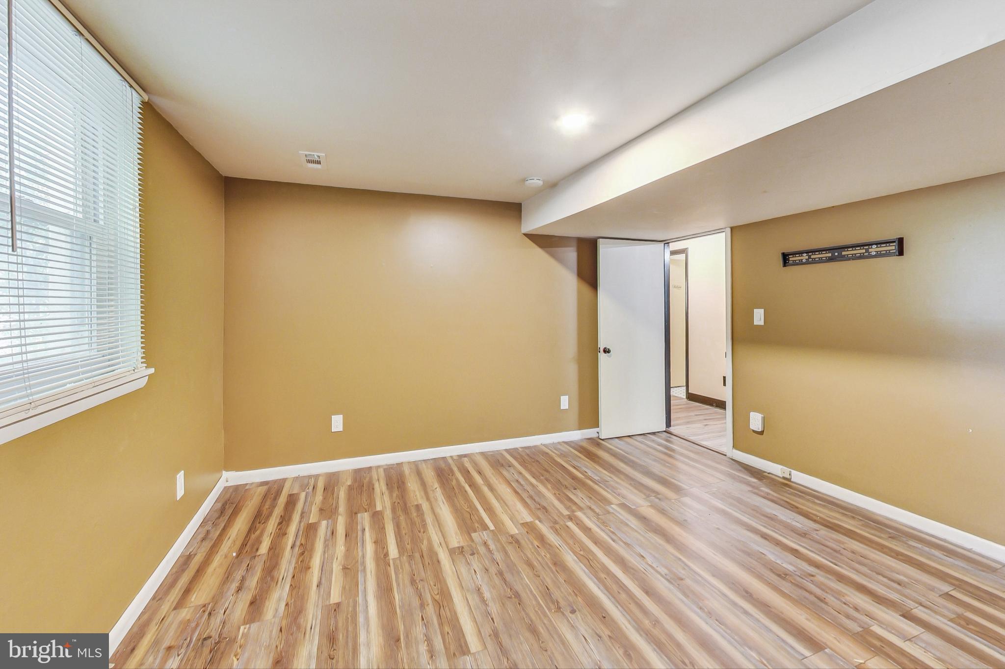 412 Walnut Drive Annapolis, MD 21403 - Photo 25 of 42 a view of an empty room with wooden floor