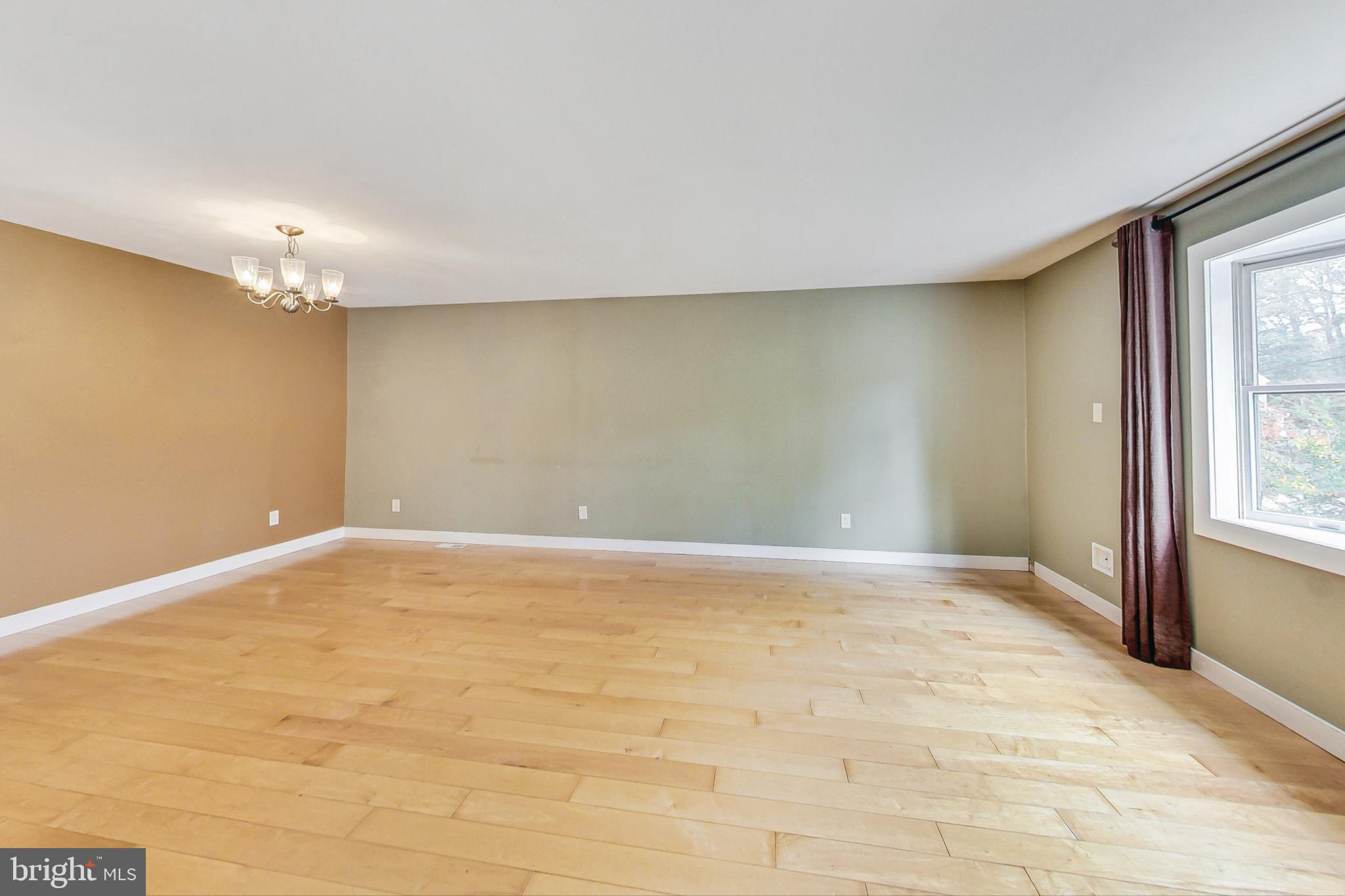 412 Walnut Drive Annapolis, MD 21403 - Photo 8 of 42 an empty room with a chandelier fan and windows