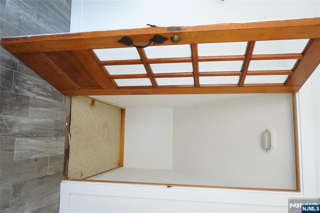 83 Roosevelt Avenue Butler, NJ 07405 - Photo 17 of 32 an empty room with wooden floor and a window