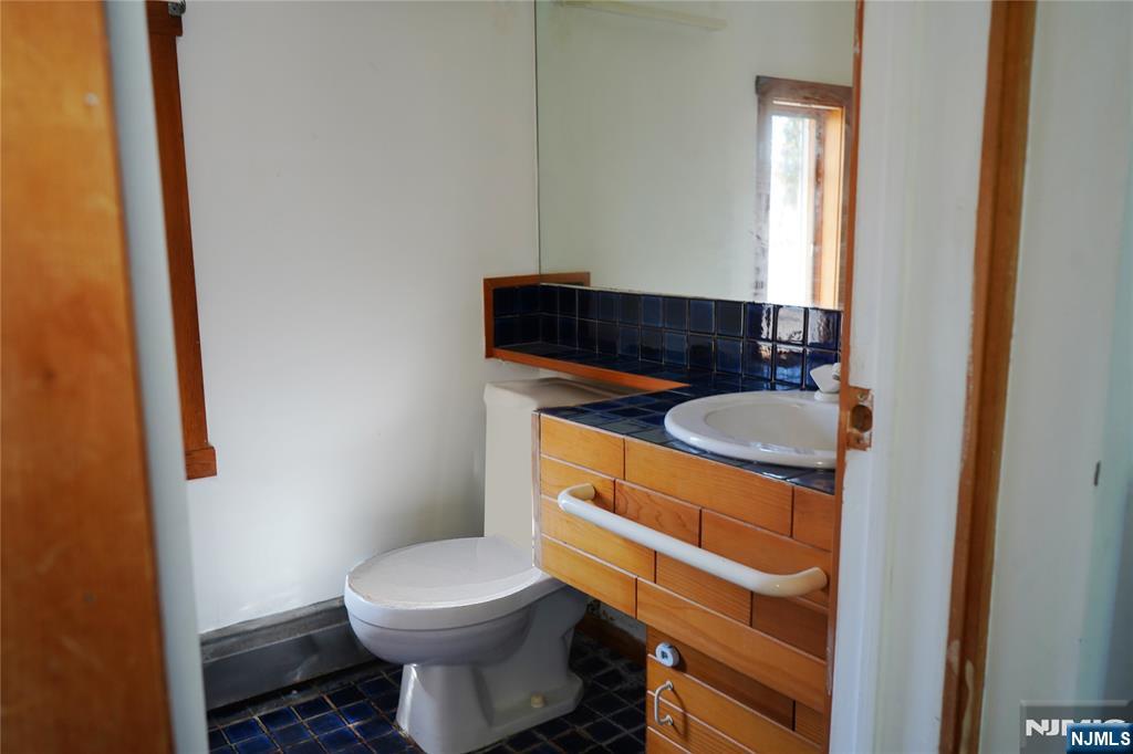 83 Roosevelt Avenue Butler, NJ 07405 - Photo 20 of 32 a bathroom with a sink and a toilet