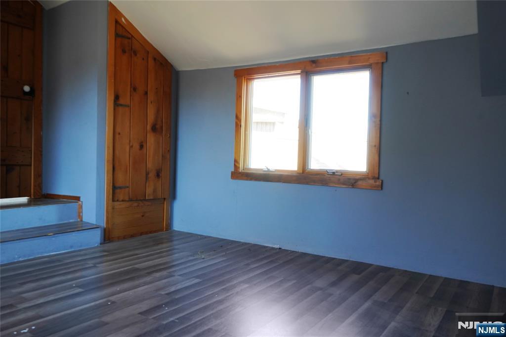 83 Roosevelt Avenue Butler, NJ 07405 - Photo 21 of 32 an empty room with wooden floor and windows