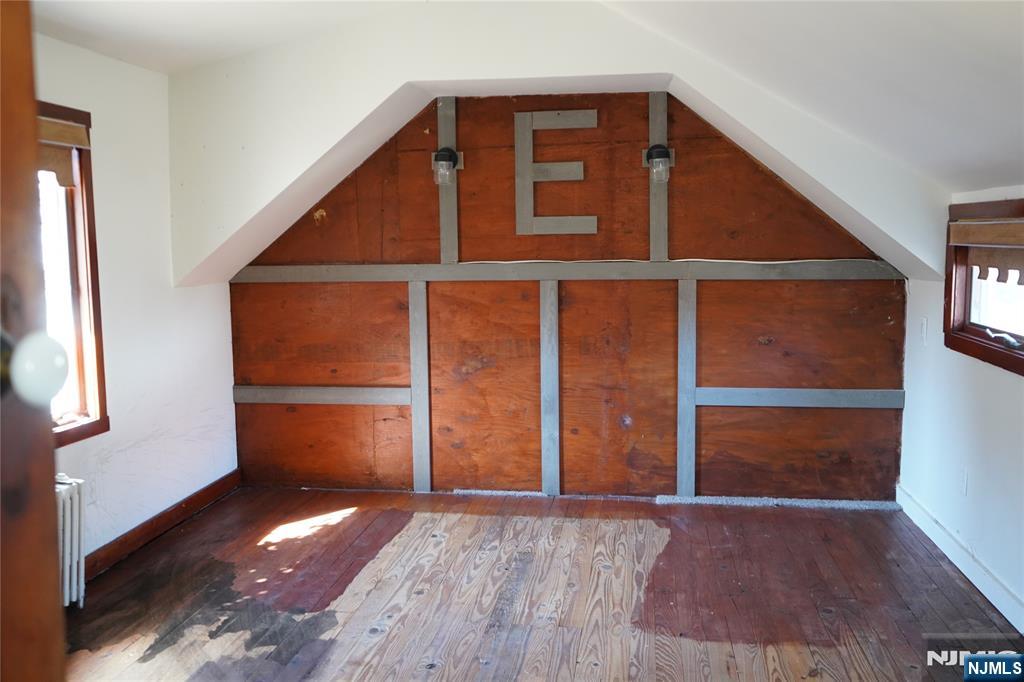 83 Roosevelt Avenue Butler, NJ 07405 - Photo 23 of 32 an empty room with wooden floor and windows