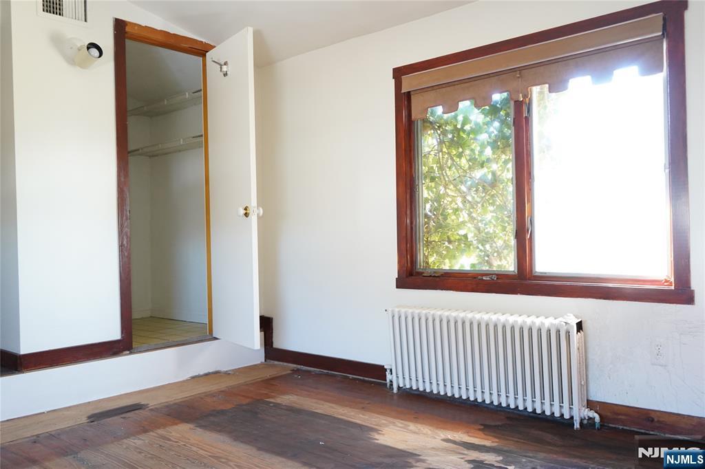 83 Roosevelt Avenue Butler, NJ 07405 - Photo 24 of 32 a view of an empty room with wooden floor and a window