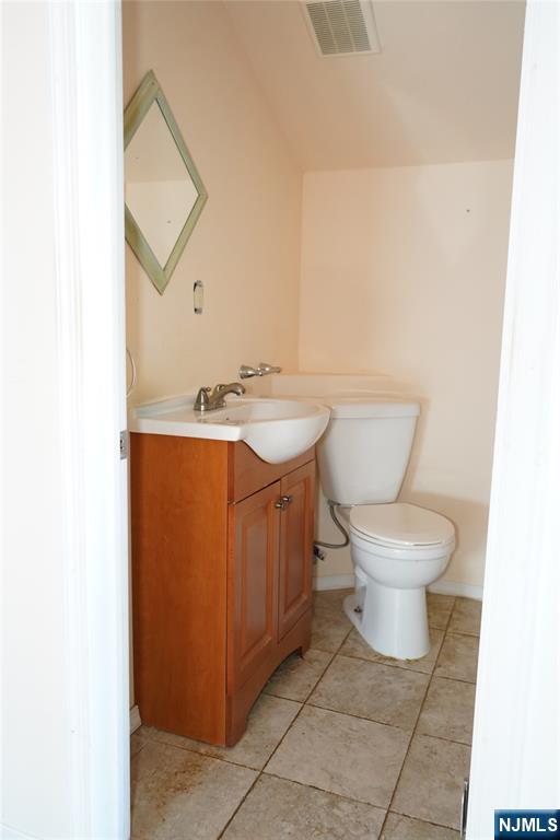 83 Roosevelt Avenue Butler, NJ 07405 - Photo 29 of 32 a white toilet sitting next to a bathroom sink