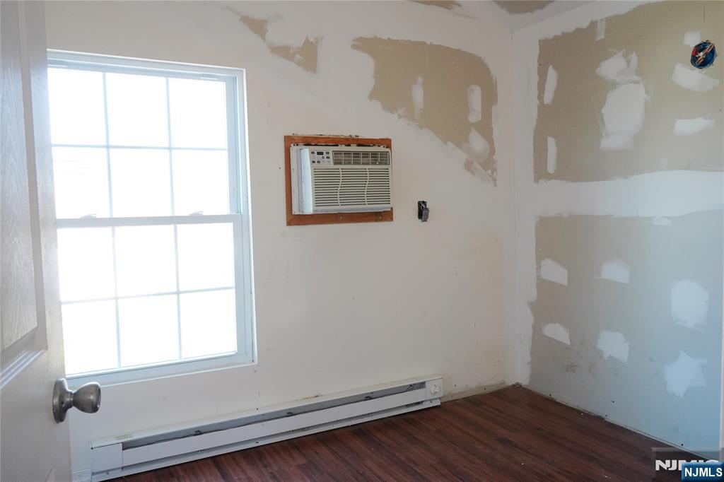 83 Roosevelt Avenue Butler, NJ 07405 - Photo 31 of 32 an empty room with wooden floor and windows
