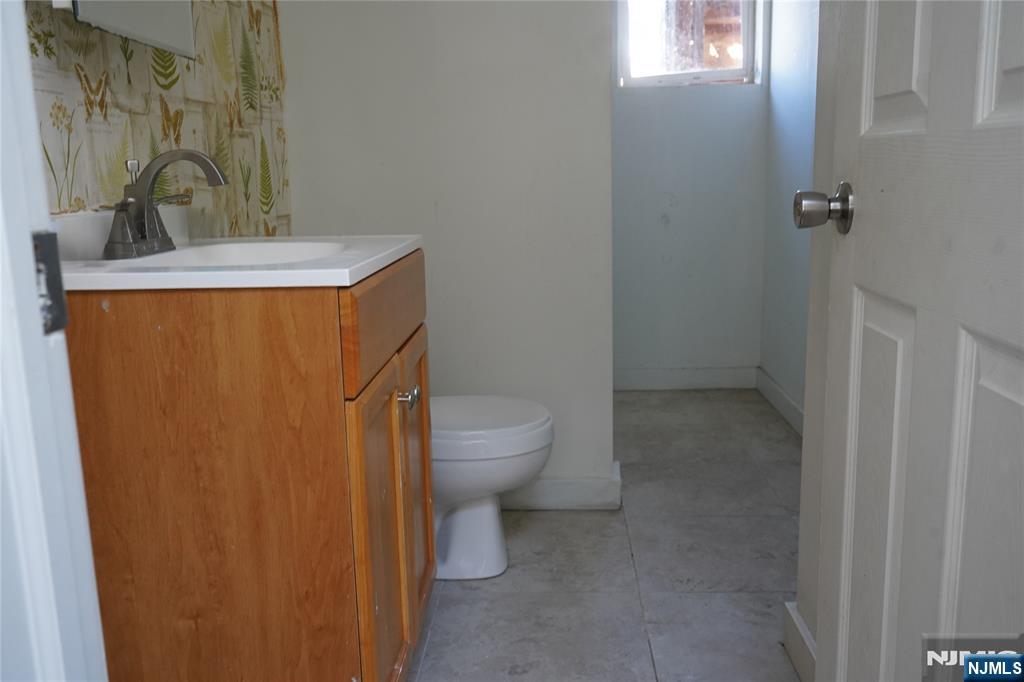 83 Roosevelt Avenue Butler, NJ 07405 - Photo 7 of 32 a bathroom with a sink a toilet and shower