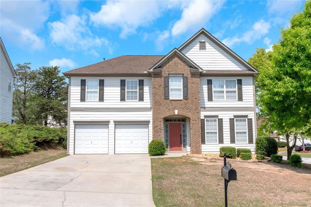 a front view of a house with a yard and garage
