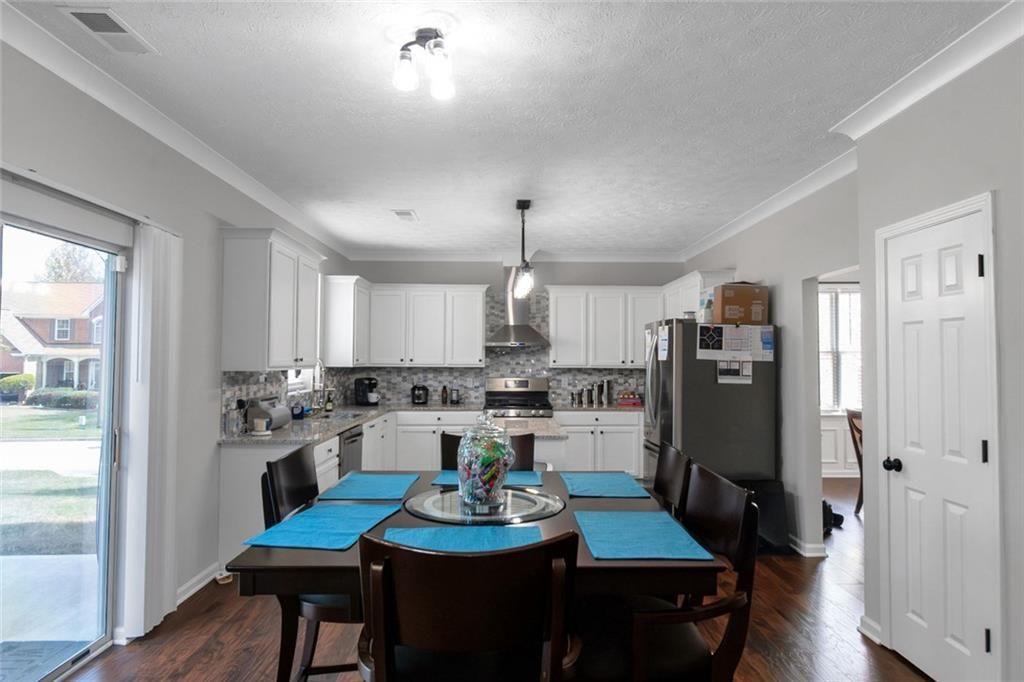 3152 Spruce Way Atlanta, GA 30349 - Photo 12 of 42 a kitchen with refrigerator and cabinets