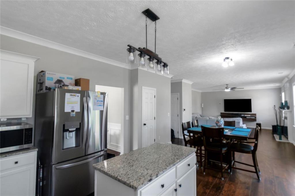 3152 Spruce Way Atlanta, GA 30349 - Photo 17 of 42 a kitchen with stainless steel appliances granite countertop a refrigerator a stove and a sink with wooden floor