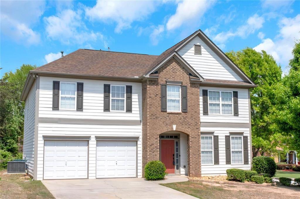 3152 Spruce Way Atlanta, GA 30349 - Photo 2 of 42 a front view of a house with a yard