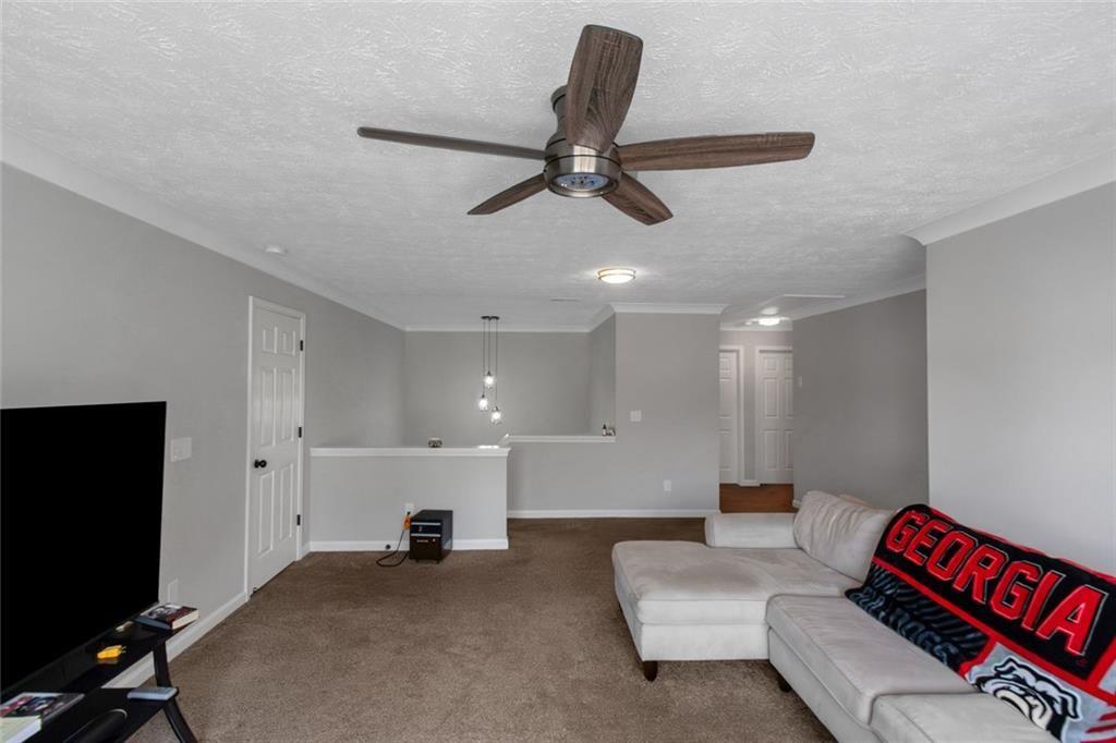 3152 Spruce Way Atlanta, GA 30349 - Photo 25 of 42 a living room with furniture and a flat screen tv
