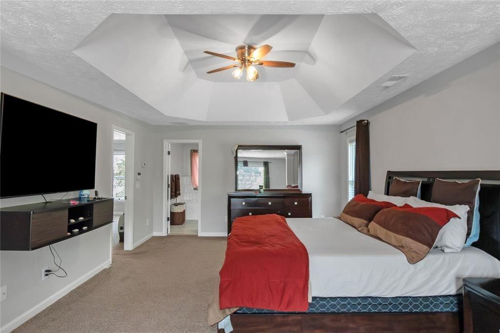 3152 Spruce Way Atlanta, GA 30349 - Photo 30 of 42 a bedroom with a bed and a flat screen tv