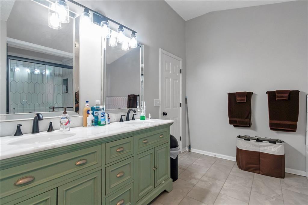 3152 Spruce Way Atlanta, GA 30349 - Photo 36 of 42 a bathroom with a double vanity sink and mirror