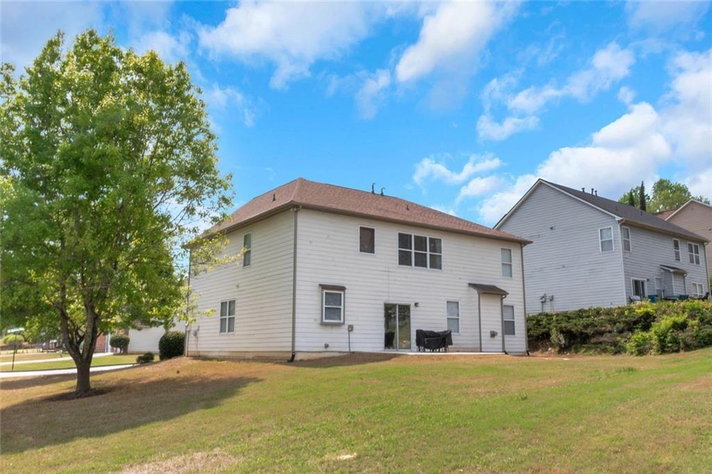 3152 Spruce Way Atlanta, GA 30349 - Photo 4 of 42 a view of a white house with a yard