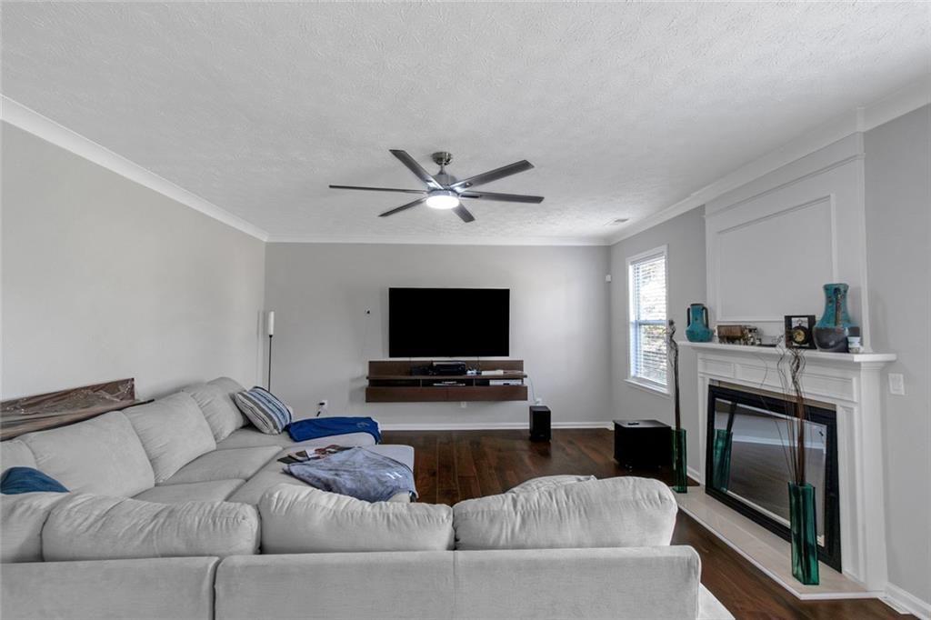 3152 Spruce Way Atlanta, GA 30349 - Photo 6 of 42 a living room with furniture a fireplace and a flat screen tv
