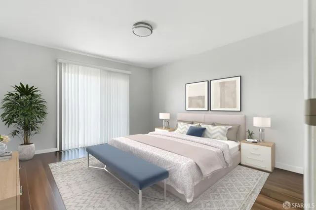 a bedroom with a large bed and a potted plant