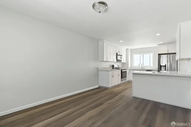 a view of a kitchen with wooden floor