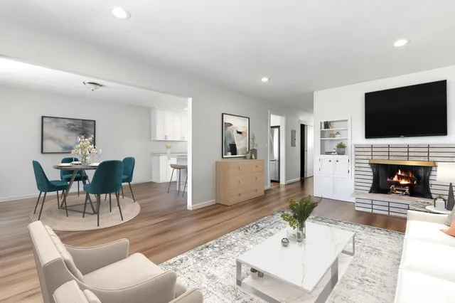 a living room with furniture a flat screen tv and a fireplace