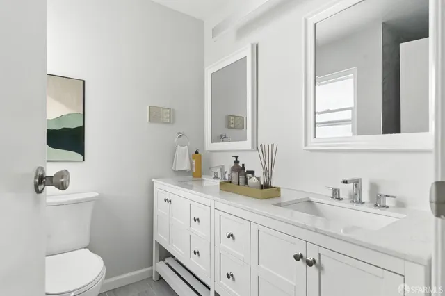 a bathroom with a toilet sink and mirror