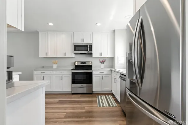a kitchen with stainless steel appliances a refrigerator stove and sink