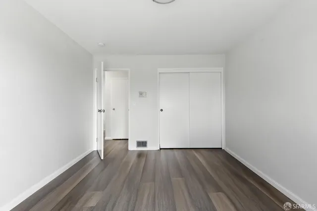 a view of a room with wooden floor