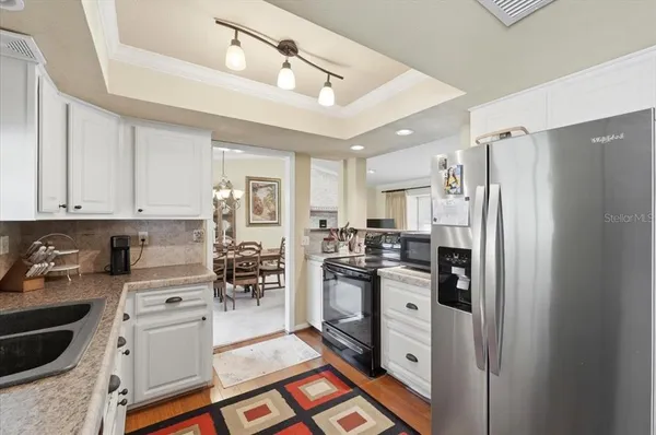 a kitchen with a sink stove and cabinets