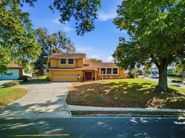 an aerial view of a house with a yard basket ball court and outdoor seating