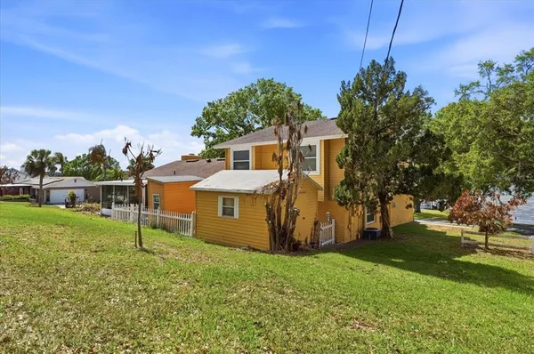 a aerial view of a house with a yard and garden