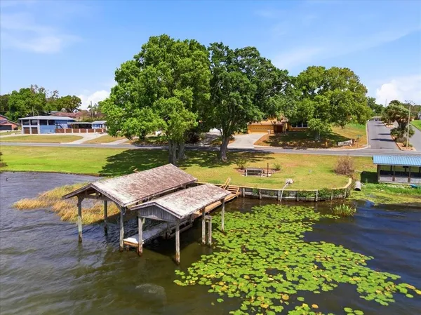 a view of a swimming pool with a patio and a yard