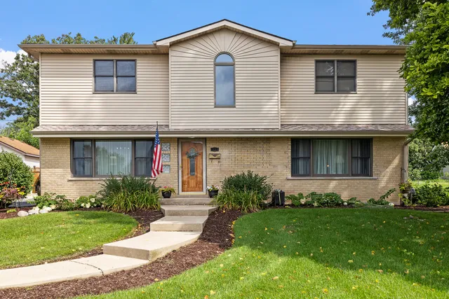 a front view of a house with a yard and porch