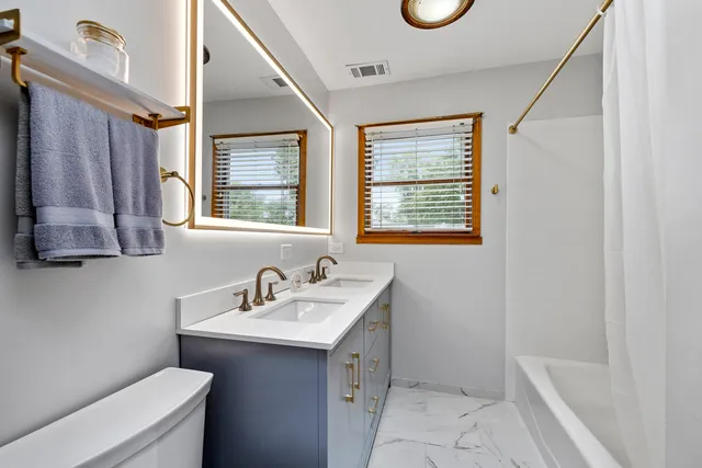 a bathroom with a sink a toilet and a bathtub