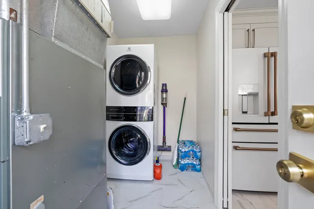 a utility room with sink dryer and washer