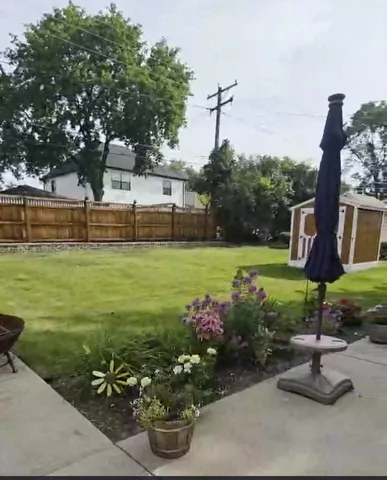 a view of a garden with plants and a bench