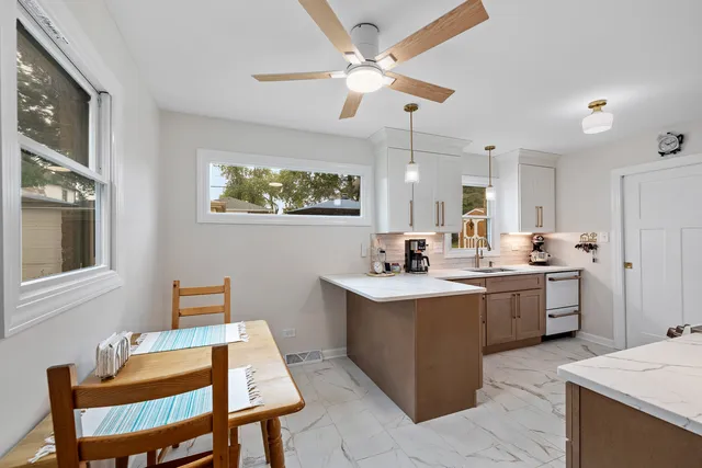a kitchen with a sink cabinets and window