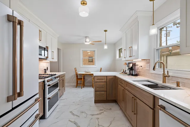 a kitchen with a sink stove and refrigerator