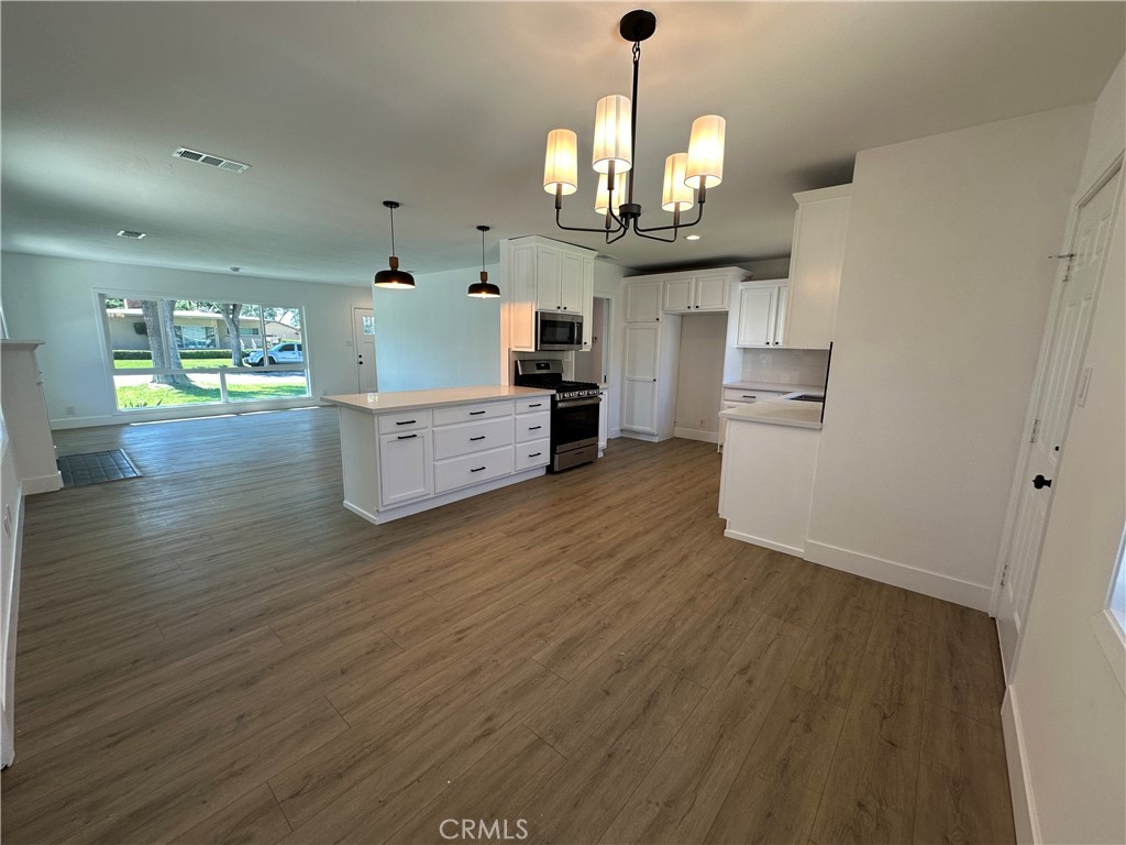 4561 Cover Street Riverside, CA 92506 - Photo 14 of 47 a view of a kitchen with cabinets and wooden floor