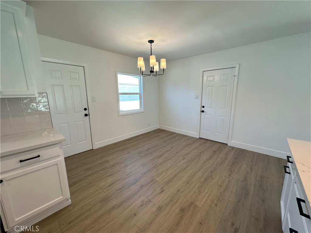 4561 Cover Street Riverside, CA 92506 - Photo 21 of 47 an empty room with wooden floor and windows