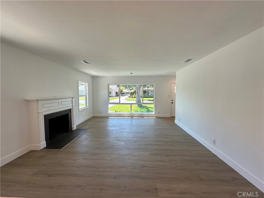 4561 Cover Street Riverside, CA 92506 - Photo 23 of 47 a view of empty room with fireplace and wooden floor