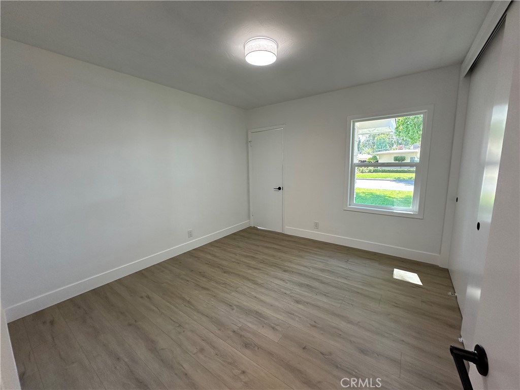 4561 Cover Street Riverside, CA 92506 - Photo 30 of 47 an empty room with wooden floor and windows