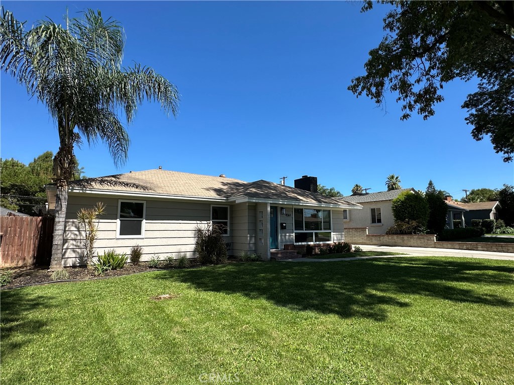 4561 Cover Street Riverside, CA 92506 - Photo 3 of 47 a front view of a house with a yard table and chairs
