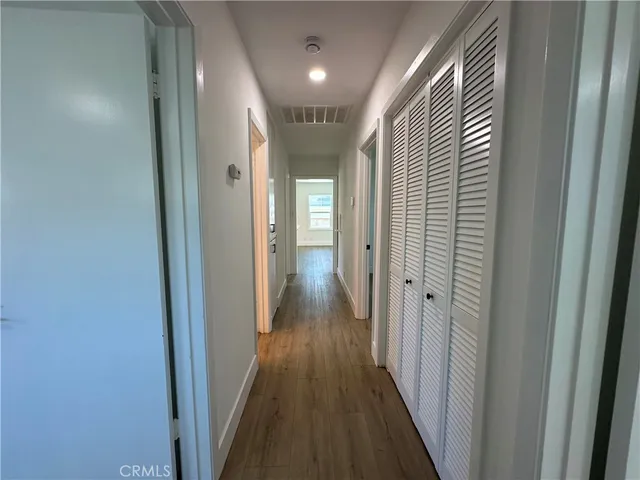 a view of hallway with wooden floor