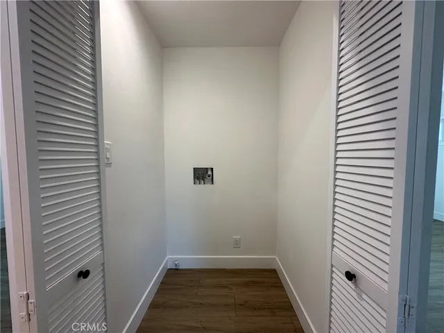 a view of a room with wooden floor